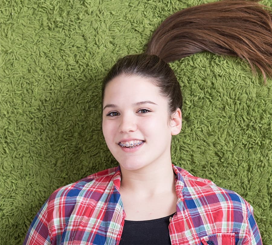 Teen with braces smiling confidently