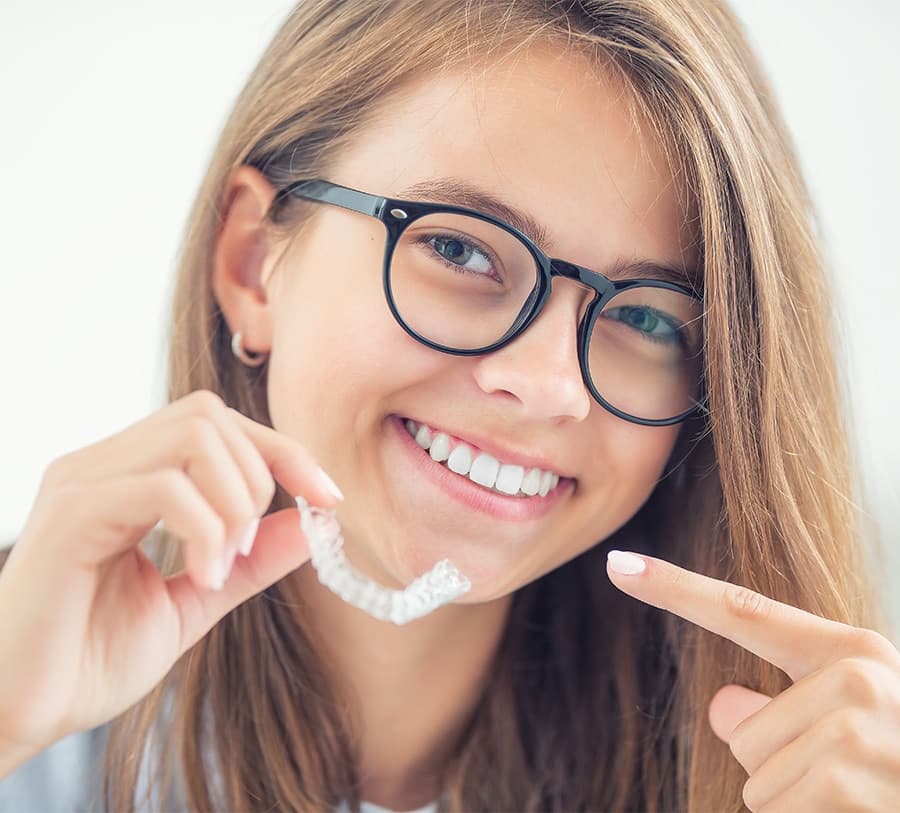 Teen with Invisalign aligners